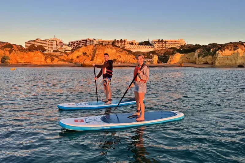 Two people doing stand-up paddleboarding in Lagos